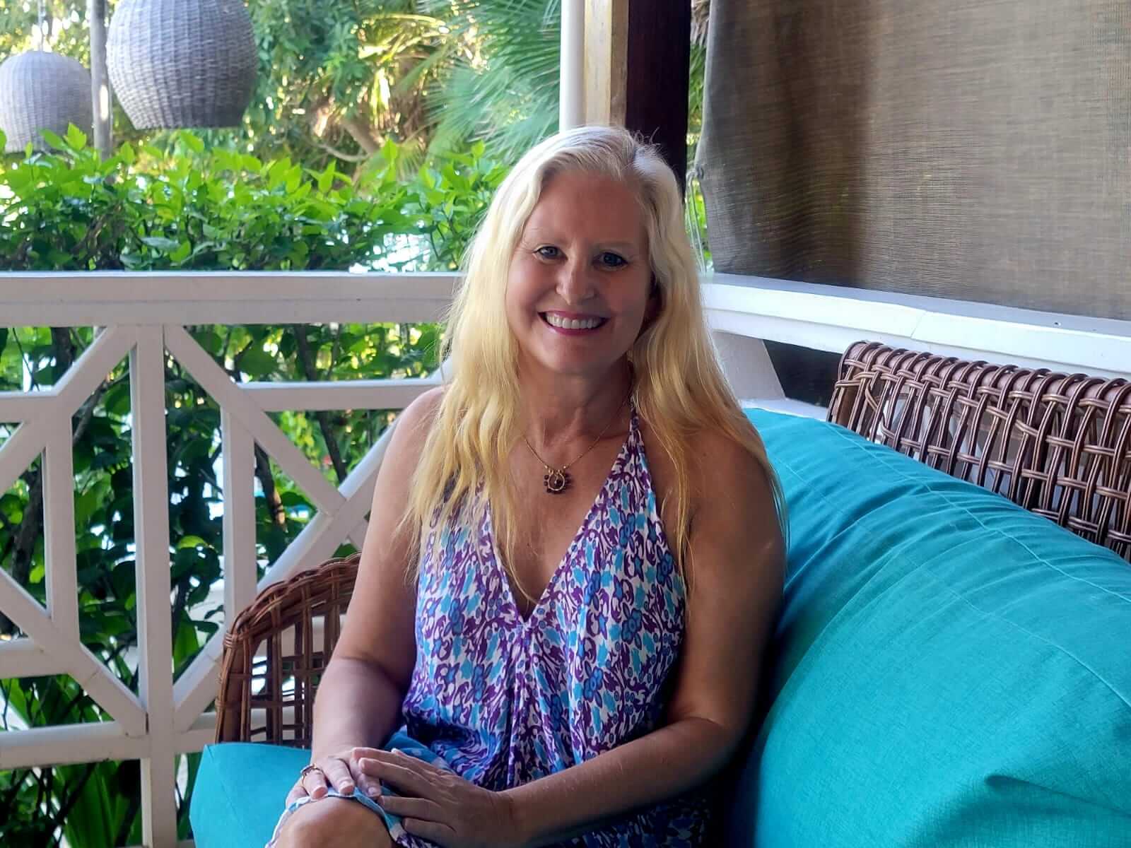 jyll-belize-teal-couch-relaxed Jyll Hoyrup relaxing on a teal couch in Belize, warm and approachable